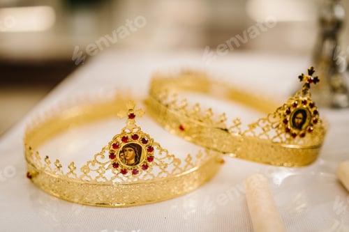 Preview: Two golden crown with red gemstones on altar in church. traditional wedding ceremony, space for