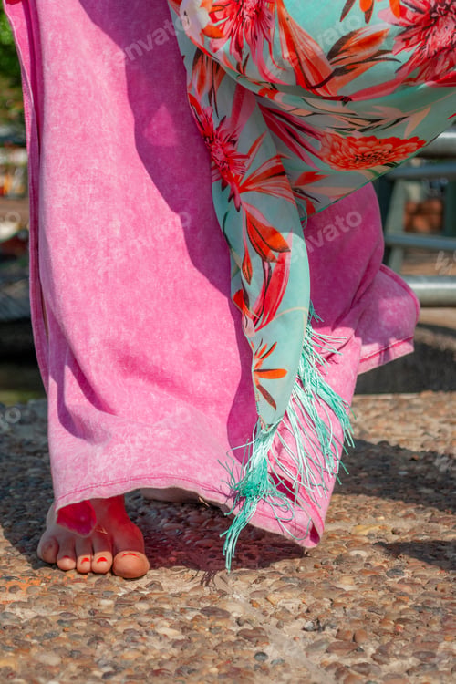 Preview: Close up of woman's legs while walking barefooted.