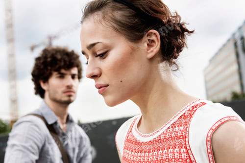 Preview: Germany, Berlin, Young couple, woman looking down, side view, portrait, close-up
