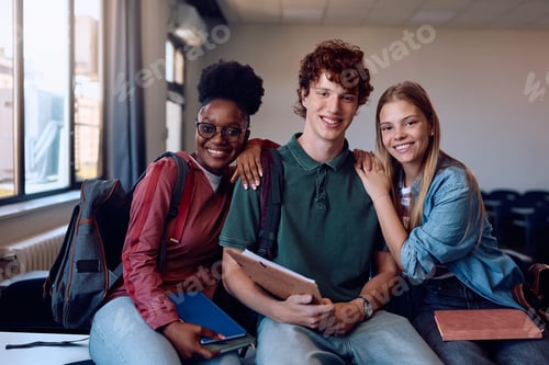 Preview: Happy college students in the classroom looking at camera.