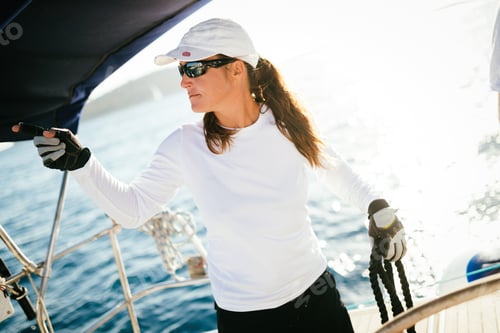 Preview: Attractive strong woman sailing with her boat