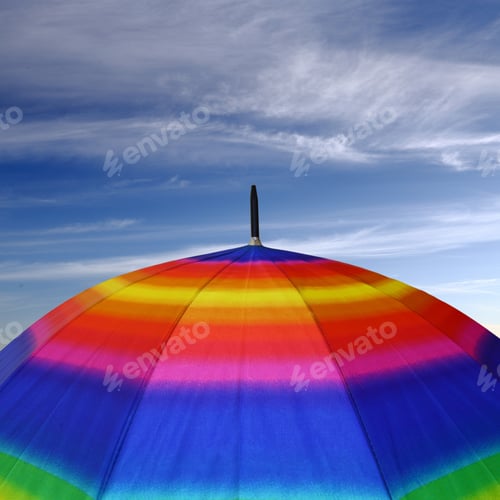 Preview: Rainbow colored umbrella top with blue sky above it