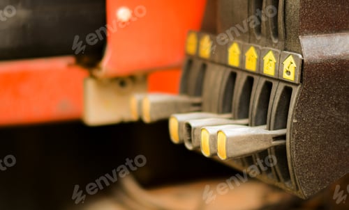 Preview: Technician's hand is controlling the lifting crane on the car.