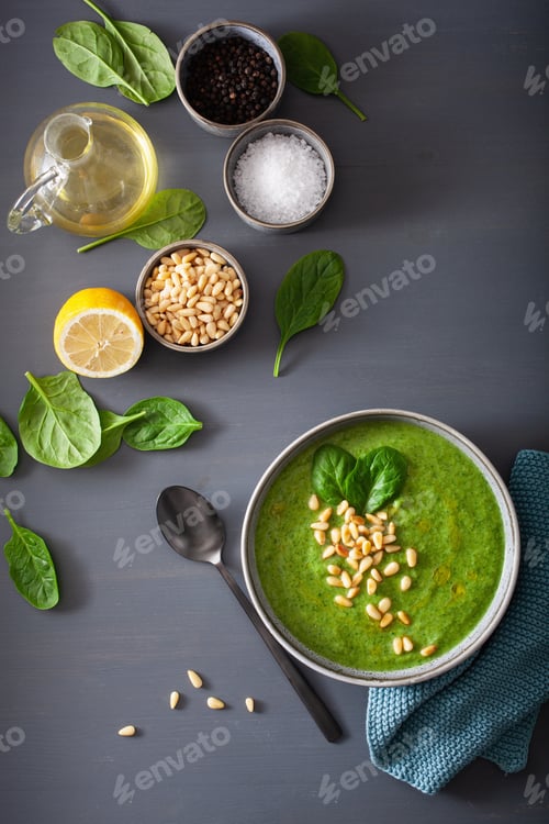 Preview: green creamy cauliflower spinach soup on gray background