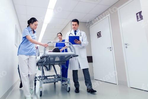 Preview: medics with woman on hospital gurney at emergency