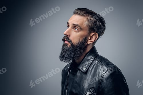 Preview: Bearded male dressed in black leather jacket.