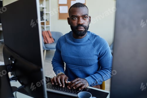 Preview: African American Man Using Computer at Home Office