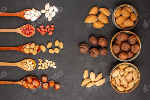 Preview: top view fresh nuts peanuts and other nuts on dark background nuts wood plant many