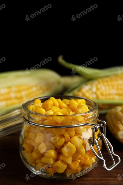 Preview: Tasty sweet corn kernels in jar on wooden table