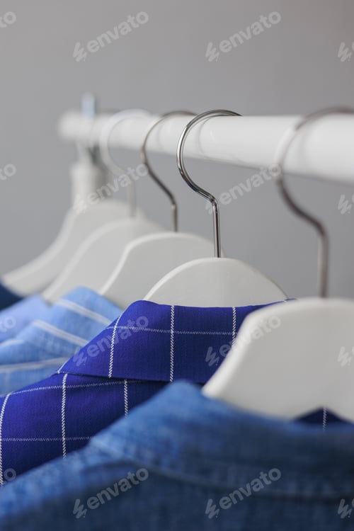 Preview: Neat Row of Blue Shirts on Hangers