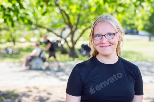 Preview: Portrait of blonde teenage girl (14-15) in park
