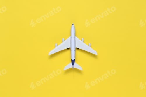 Preview: Toy airplane on yellow table top view