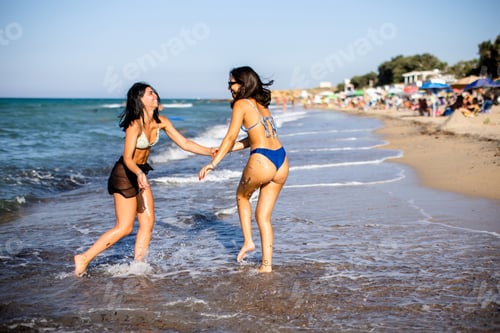 Preview: Two pretty young woman having fun on the seaside