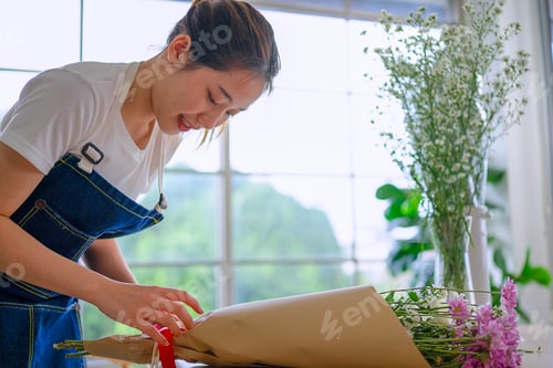 Preview: Young entrepreneurs are working at florist shop.