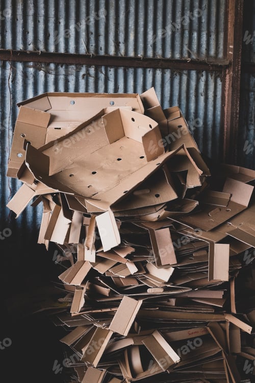 Preview: Close up of heap of crumpled cardboard boxes on a farm.