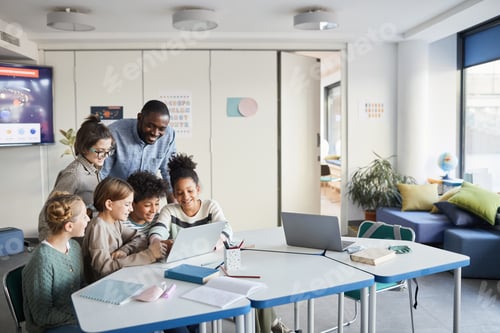 Preview: Group of Kids Looking at Computer Screen in School