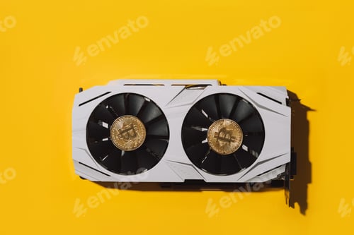 Preview: There are two bitcoins on the video card on yellow background. Cryptocurrency mining concept