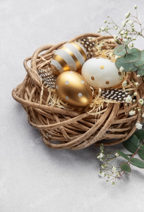 Preview: Easter eggs resting in a decorative nest with feathers and gypsophila flowers