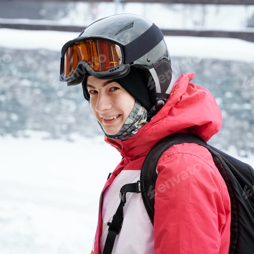 Preview: Beautiful female skier standing outdoors on winter day.
