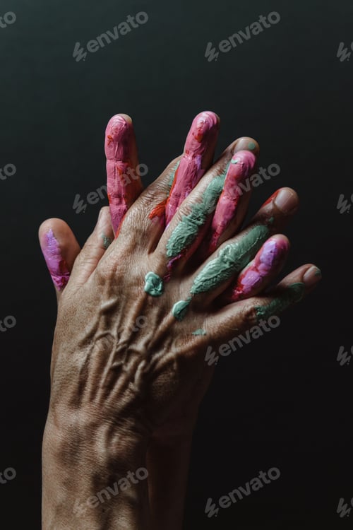 Preview: Fun leisure. Creative female artist showing hands dirty with different colors paint.Dark background.