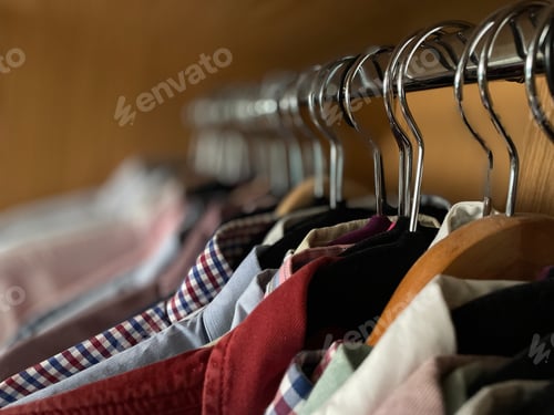 Preview: Colorful Shirts Hanging Neatly in Closet Interior