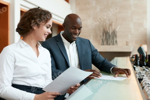 Preview: Happy young business people at cafe with some documents