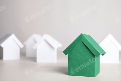 Preview: Green and white house models on light background