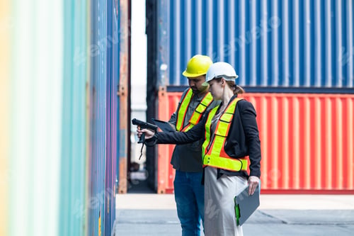Preview: Warehouse engineer inspects merchandise with large customer at industrial container yard.