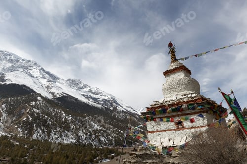 Preview: Walking along a mountain path towards a peak, passing a white stupa with colorful prayer flags