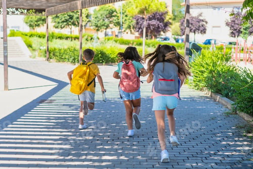 Preview: Children running toward school building with backpacks