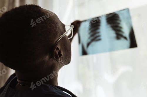 Preview: Close-up portrait of african young doctor, therapeutic or medical advisor at work, idoors . Concept