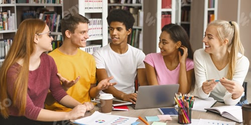 Preview: Group of multinational teenagers working on project at library