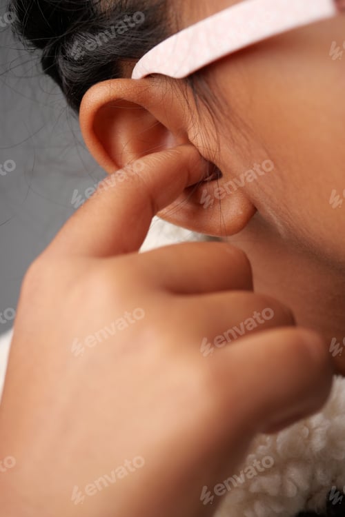 Preview: Child gently touching ear during a quiet moment