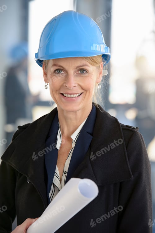 Preview: Portrait of businesswoman wearing blue hard hat in new office