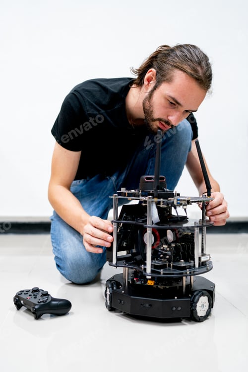 Preview: Smart Caucasian professional engineer or technician worker man check and maintenance small robot