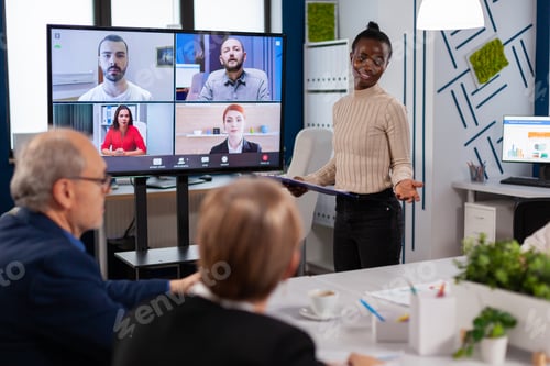 Preview: Black manager woman talking with remotely colleagues on