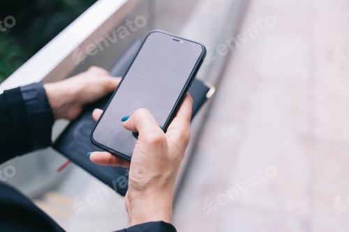 Preview: Unrecognizable woman messaging on smartphone