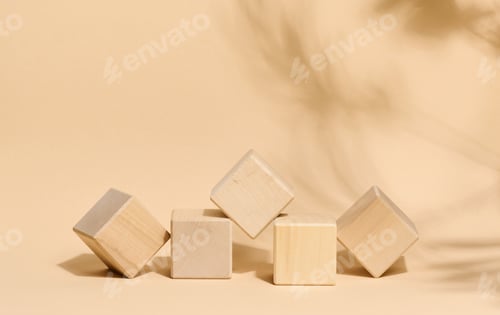 Preview: Five light wooden cubes placed in the center on a beige background with the soft shadow