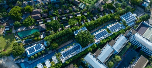Preview: Top view of blue solar photo voltaic panels system on high apartment building roof top on sunny