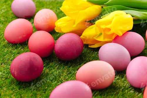 Preview: Colored Easter eggs on grass decorated with flowers