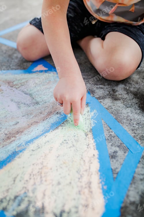 Preview: Kid painting concrete ground with a chalk education photography