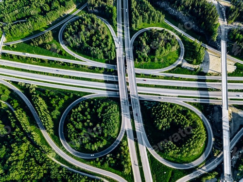 Preview: Aerial view of highway and overpass with green woods in Finland.