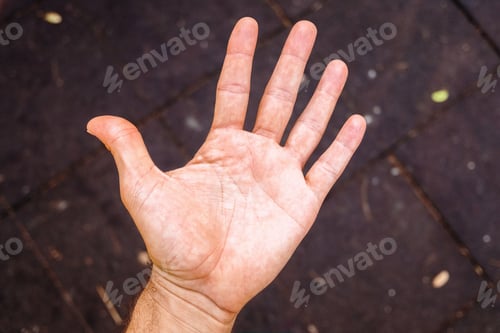 Preview: Small man's hand, open and top view, isolated on black background.