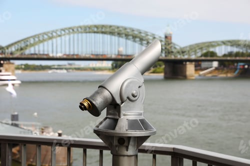 Preview: Modern public telescope near river on sunny day