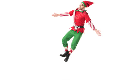 Preview: happy man in christmas elf costume jumping isolated on white background