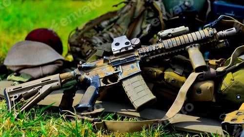 Preview: Closeup of a gun on green grass