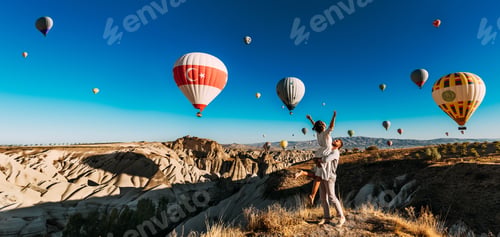 Preview: A couple in love against the background of flying balloons in Cappadocia. Travel to Turkey