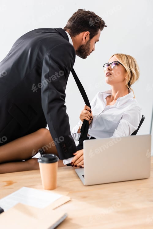 Preview: Business couple flirting and looking at each other at workplace