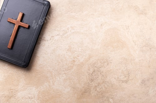 Preview: Wooden cross on Bible over marble background. Reminder of Jesus sacrifice and Christ resurrection