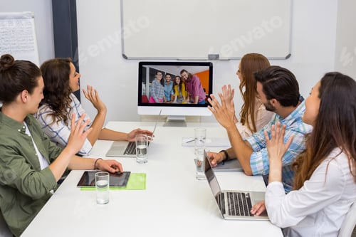 Preview: Business team having video conference with another business team